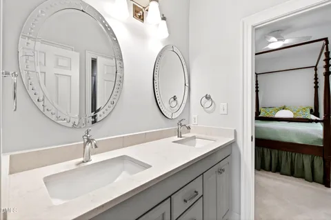 a bathroom with a sink vanity and a mirror