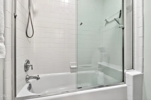 a bathroom with a glass shower door