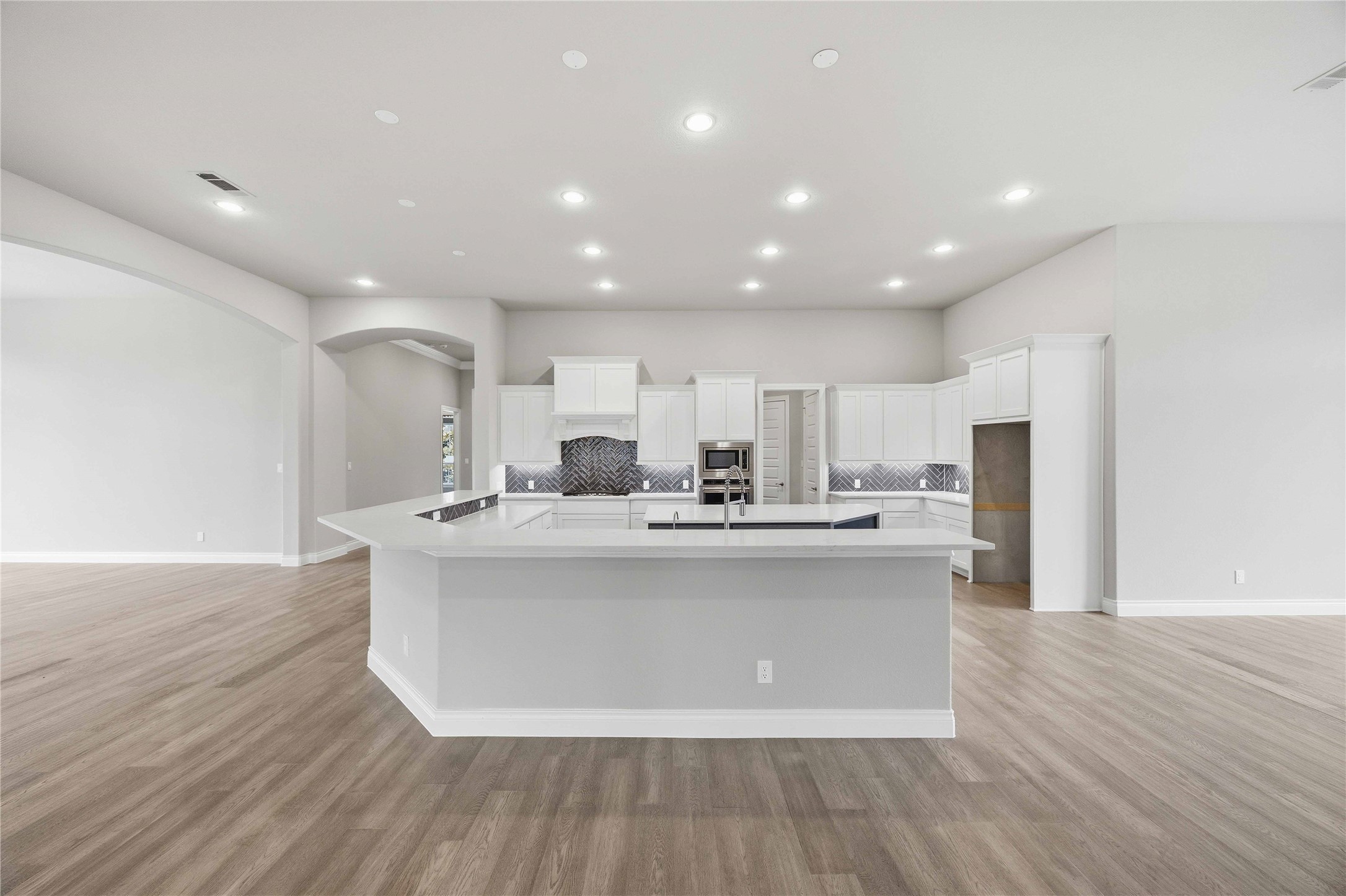 17564 Watercolor Way Conroe, TX 77302 - Photo 11 of 42 Chef's kitchen with quartz counter tops, stylish backsplash, expansive island, stainless steel appliances and walk in pantry