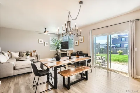 a living room with furniture a wooden floor and a chandelier