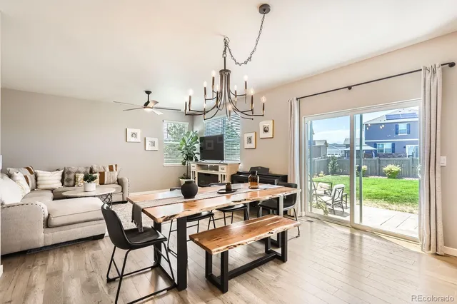 a living room with furniture a wooden floor and a chandelier