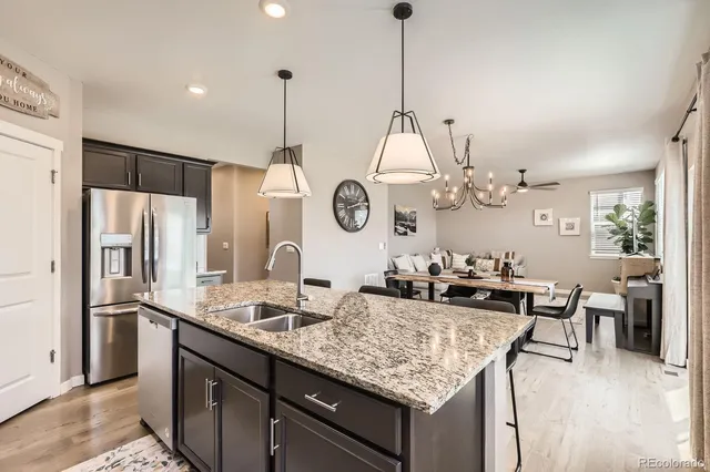 a kitchen with sink refrigerator and cabinets