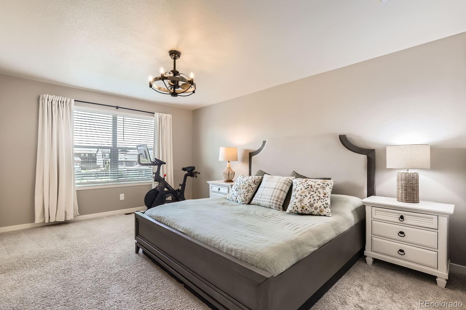 1591 Sun River Road Berthoud, CO 80513 - Photo 19 of 34 a bedroom with a bed and a window