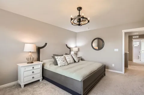 a bedroom with a bed and a chandelier