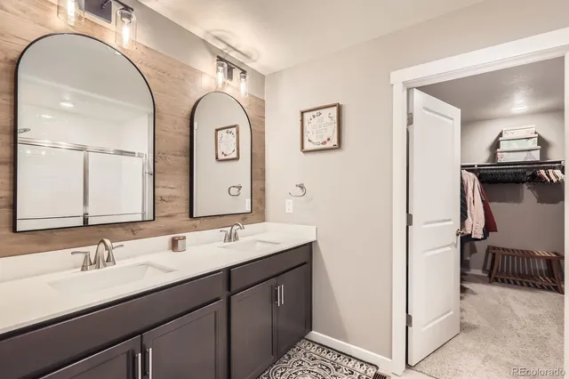 a bathroom with a double vanity sink and a mirror