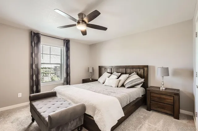 a bedroom with a bed a dresser and a window