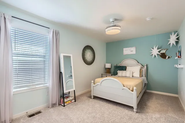 a bedroom with bed and a window