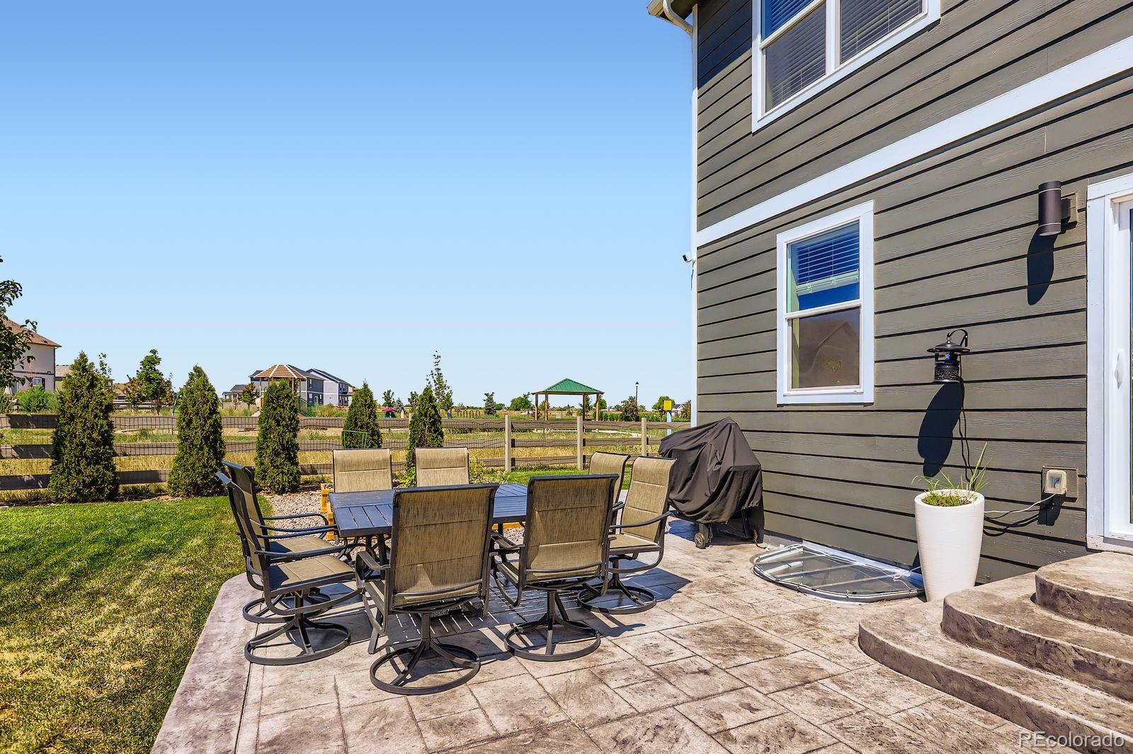 1591 Sun River Road Berthoud, CO 80513 - Photo 30 of 34 a view of a patio with table and chairs near a yard