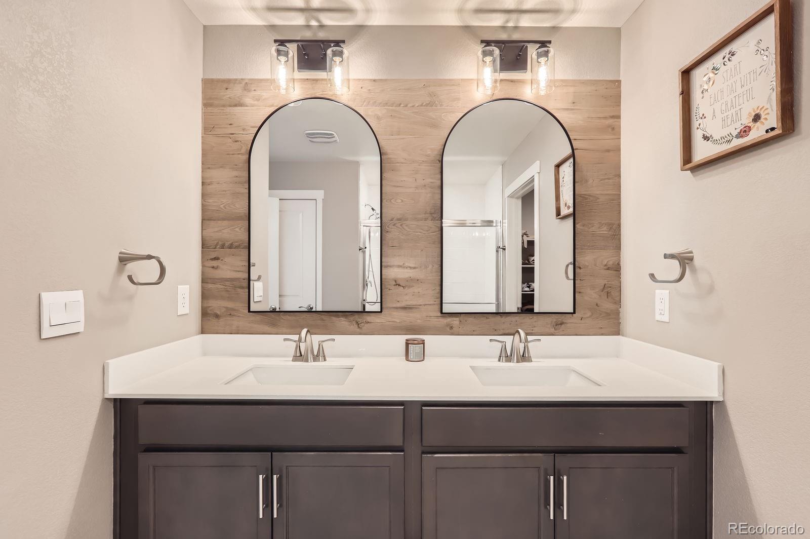 1591 Sun River Road Berthoud, CO 80513 - Photo 3 of 34 a bathroom with double sink and a mirror