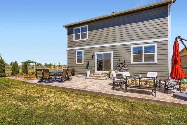 a swimming pool with outdoor seating and yard