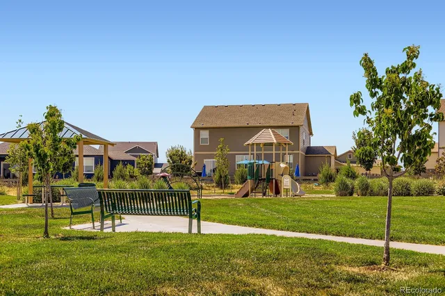 a front view of a building with a yard