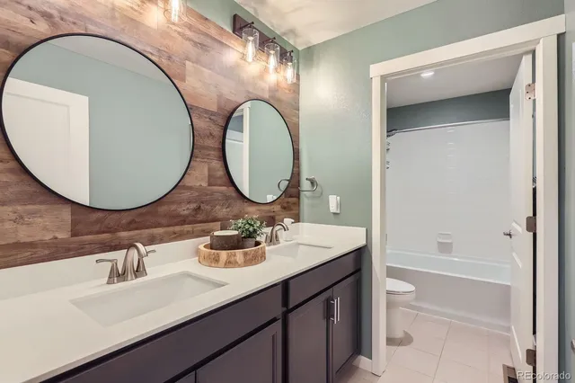 a bathroom with a double vanity sink and a mirror