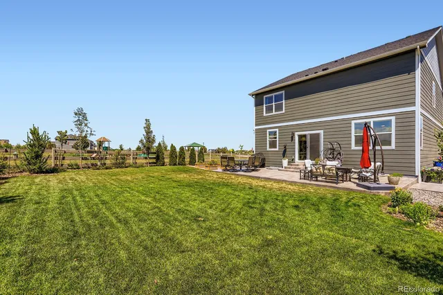 a view of a house with backyard porch and sitting area