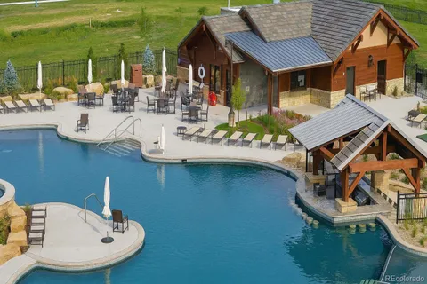 swimming pool view with a seating space