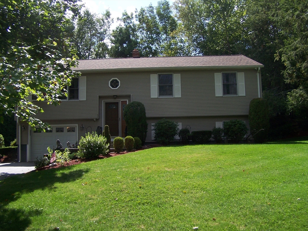94 Lower Gore Road Webster, MA 01570 - Photo 1 of 19 a front view of a house with a garden