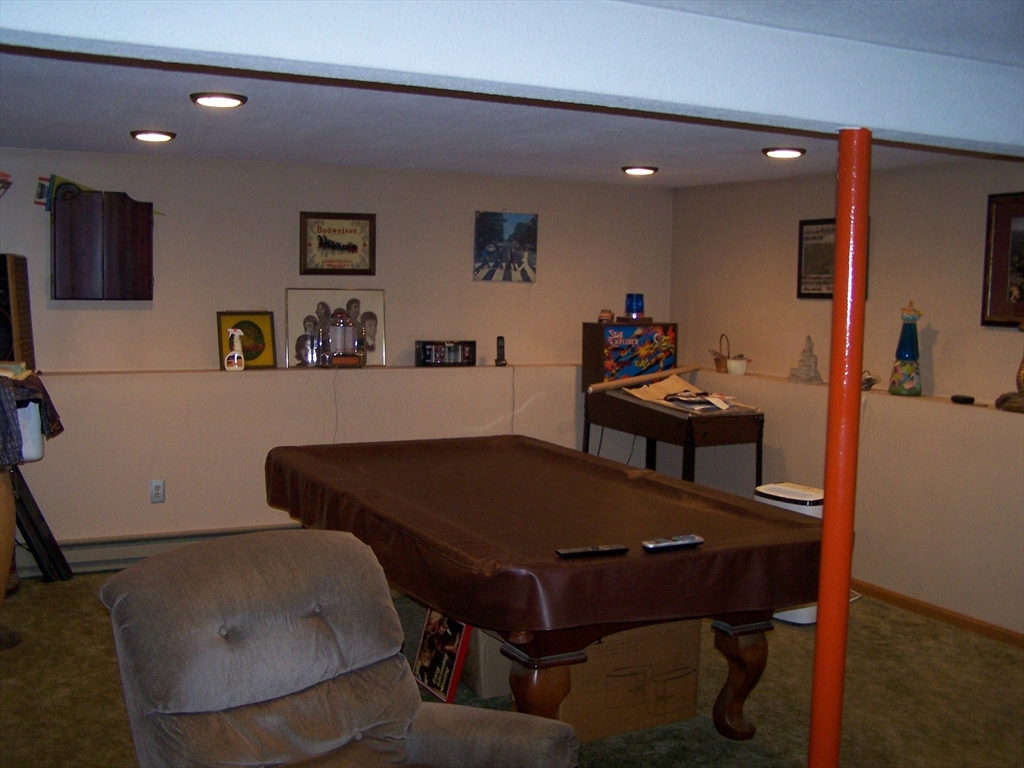 94 Lower Gore Road Webster, MA 01570 - Photo 17 of 19 a living room with furniture and a flat screen tv