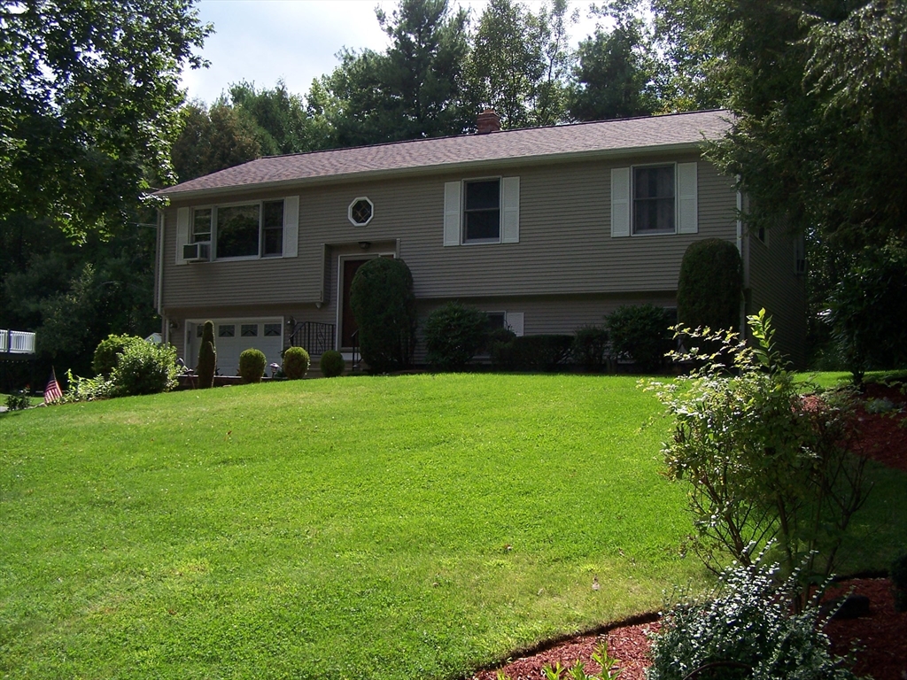 94 Lower Gore Road Webster, MA 01570 - Photo 4 of 19 a front view of a house with a garden