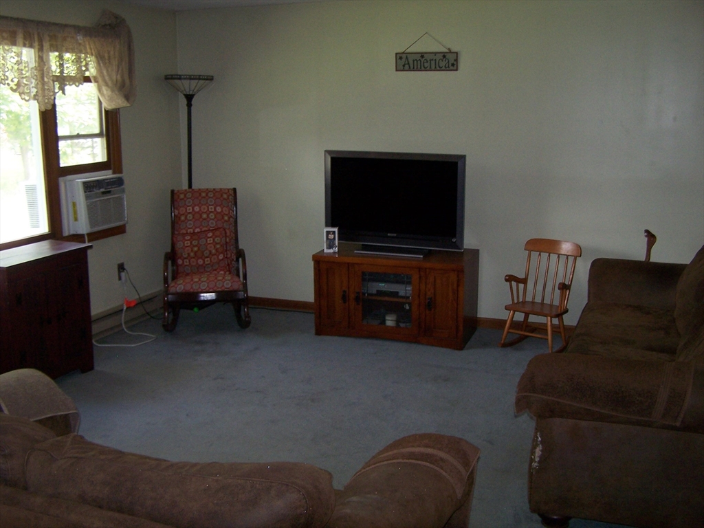 94 Lower Gore Road Webster, MA 01570 - Photo 9 of 19 a living room with furniture and a flat screen tv