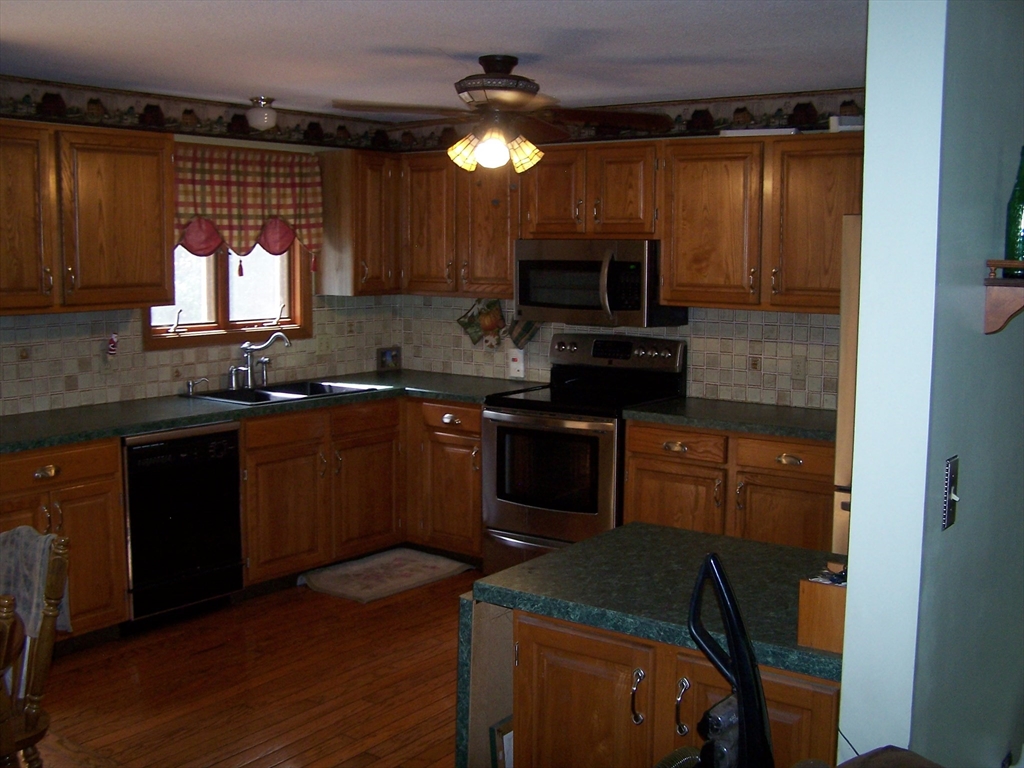 94 Lower Gore Road Webster, MA 01570 - Photo 10 of 19 a kitchen with a sink stove and microwave