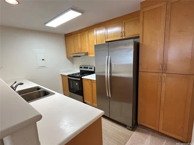 a kitchen with a refrigerator a sink and cabinets