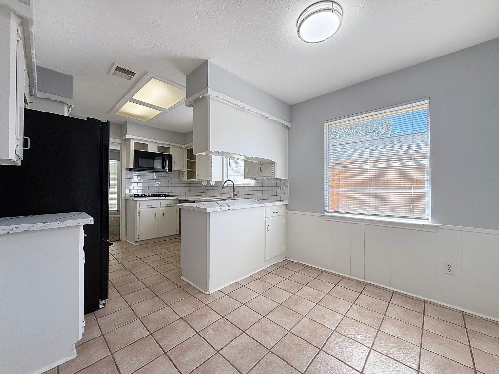 9206 Sharpview Drive Houston, TX 77036 - Photo 12 of 27 a kitchen with a sink cabinets and stainless steel appliances