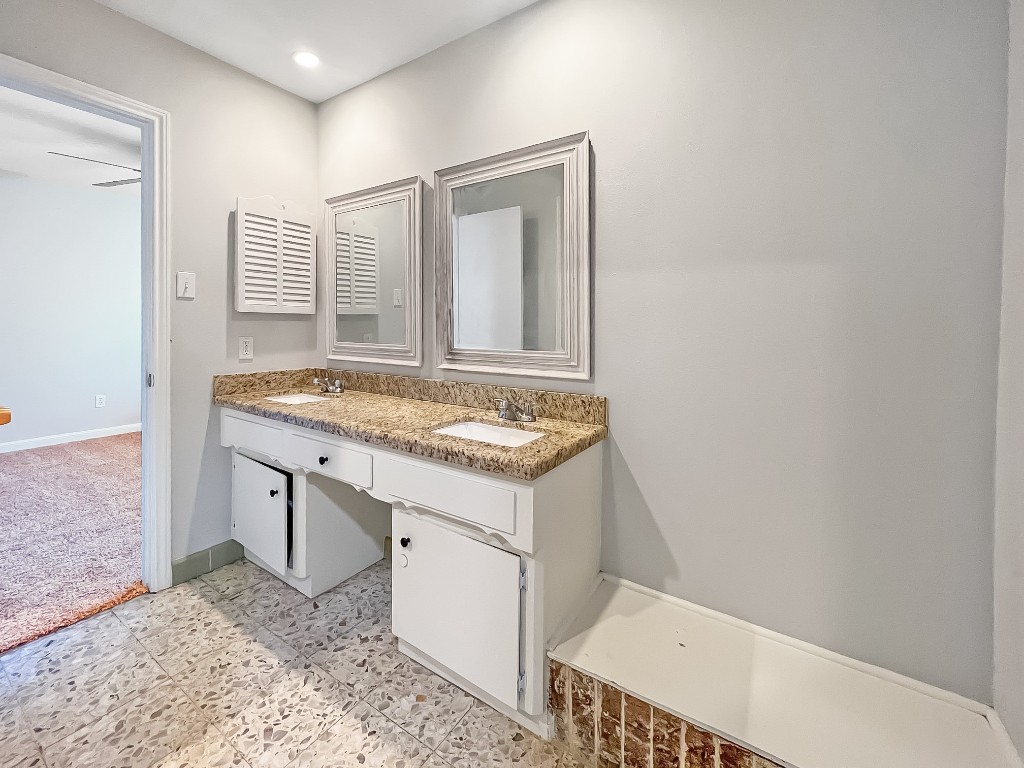 9206 Sharpview Drive Houston, TX 77036 - Photo 19 of 27 a bathroom with a sink and a mirror