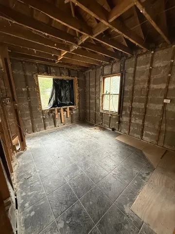 a view of a room with wooden floor and furniture