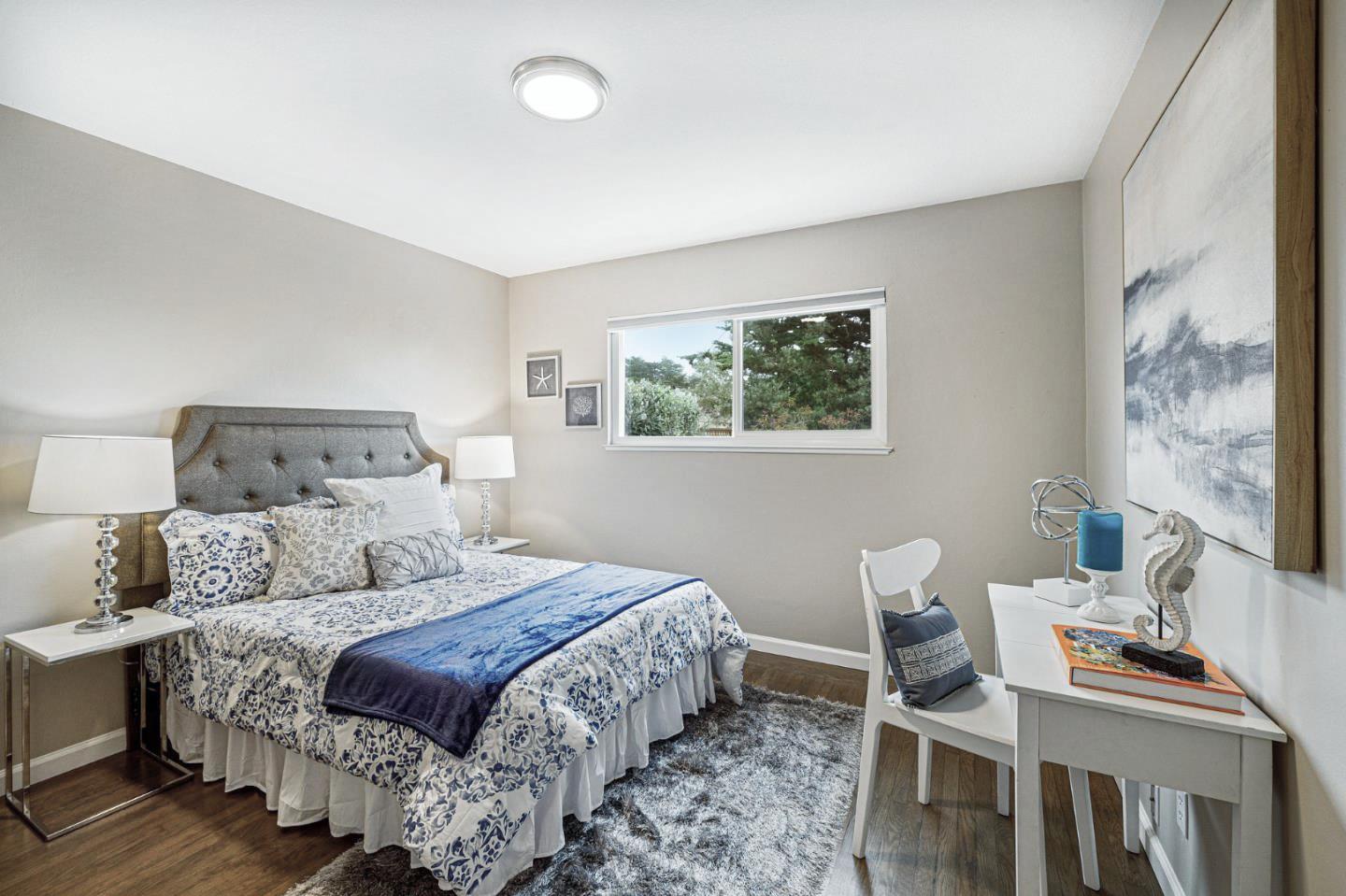 374 Bancroft Way Pacifica, CA 94044 - Photo 17 of 23 a bedroom with a bed and a table in it