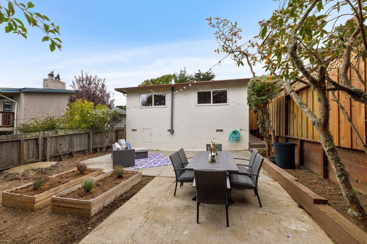 374 Bancroft Way Pacifica, CA 94044 - Photo 20 of 23 a view of a patio with couches table and chairs and potted plants
