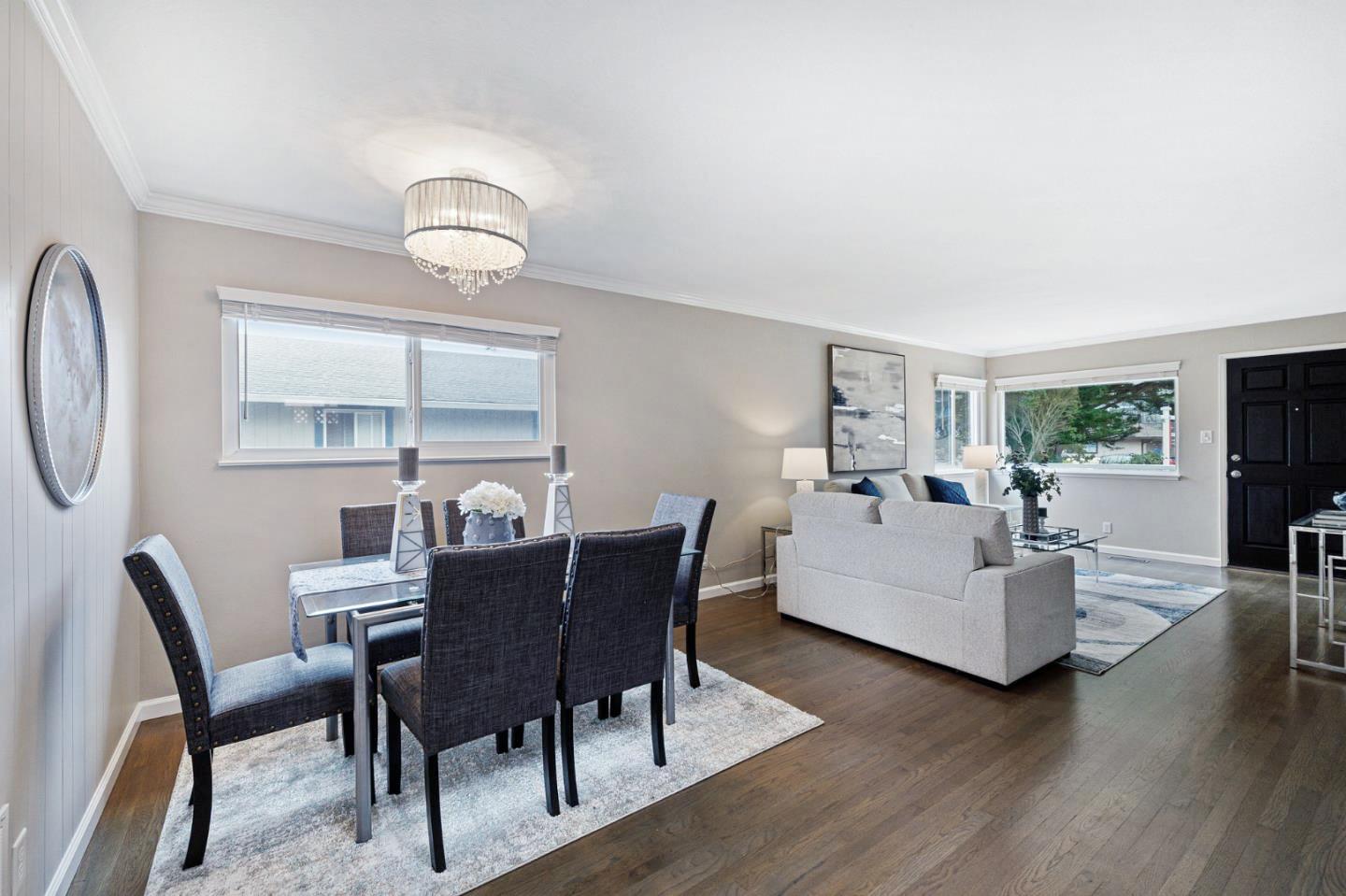 374 Bancroft Way Pacifica, CA 94044 - Photo 5 of 23 a view of a dining room with furniture wooden floor and a chandelier