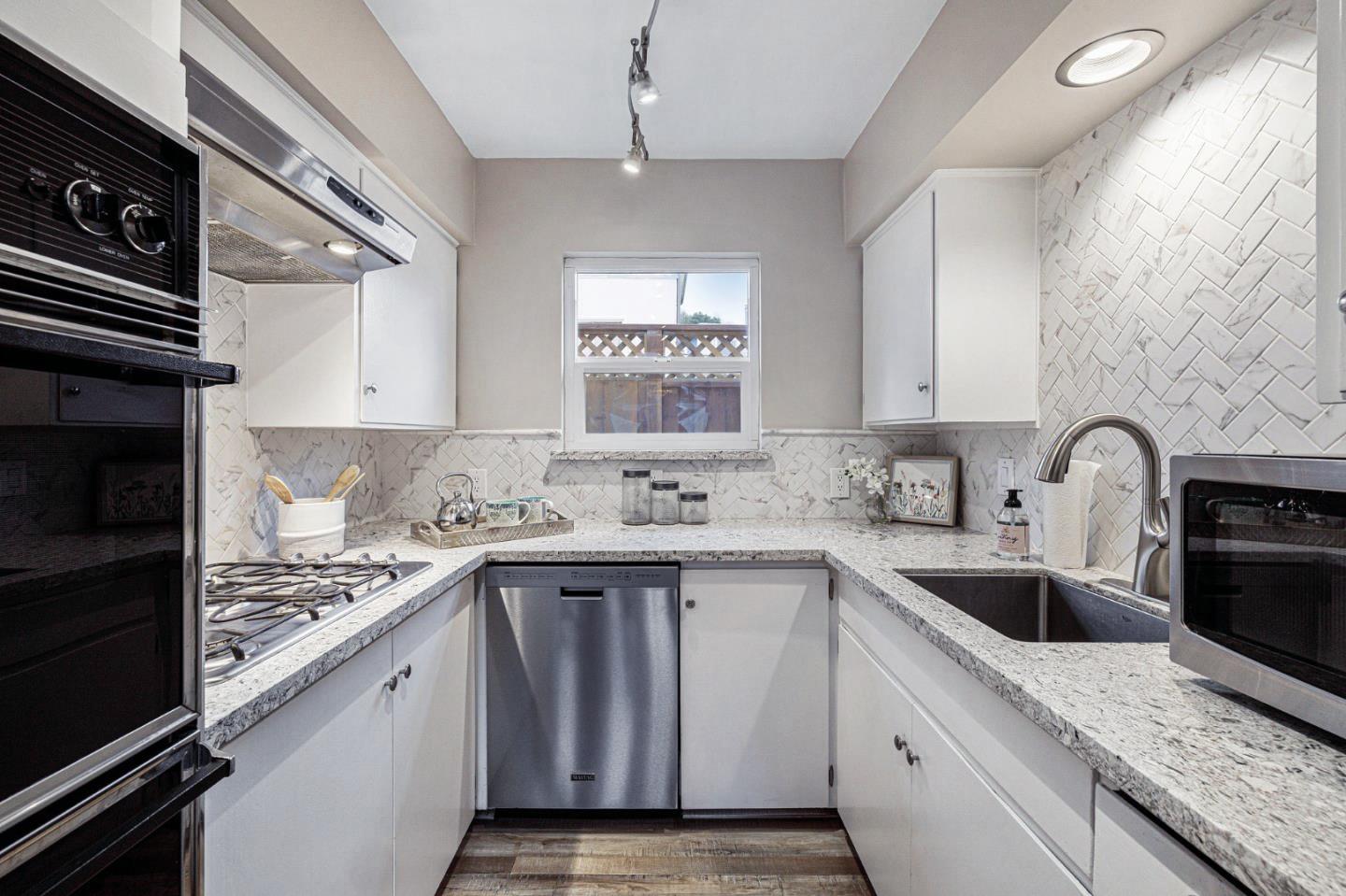 374 Bancroft Way Pacifica, CA 94044 - Photo 8 of 23 a kitchen with a sink stove top oven and cabinets