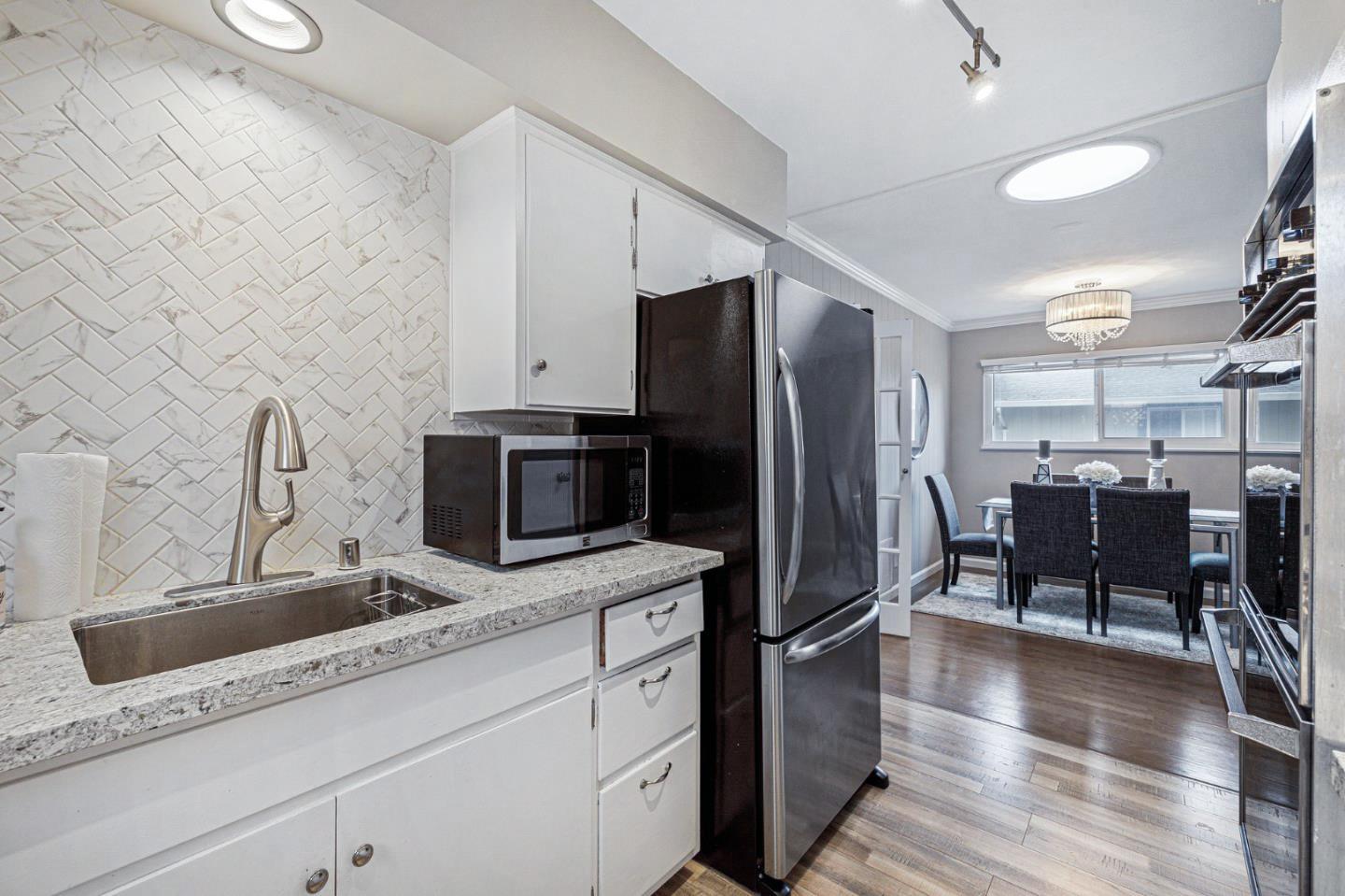 374 Bancroft Way Pacifica, CA 94044 - Photo 9 of 23 a kitchen with stainless steel appliances granite countertop a refrigerator and a sink