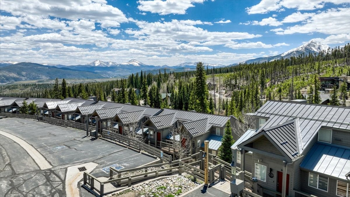 91399 Ryan Gulch Road, Unit B6 Silverthorne, CO 80498 - Photo 34 of 36 a view of a patio with table and chairs with wooden floor and fence