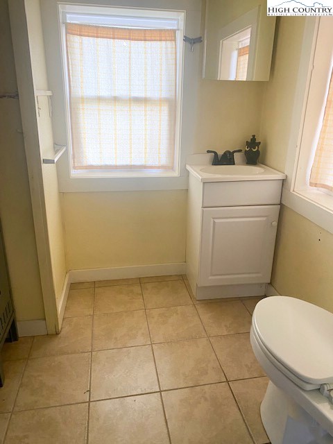 23 Millards Way Sparta, NC 28675 - Photo 16 of 46 a bathroom with a sink a toilet and a window