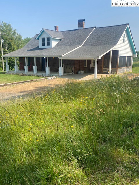 23 Millards Way Sparta, NC 28675 - Photo 20 of 46 a front view of a house with a garden