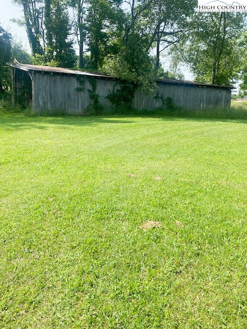 23 Millards Way Sparta, NC 28675 - Photo 32 of 46 a backyard of a house with lots of plants and tree
