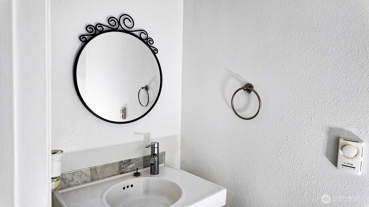 10601 Southeast 252nd Street, Unit O2 Kent, WA 98030 - Photo 11 of 18 a bathroom with a sink and a mirror