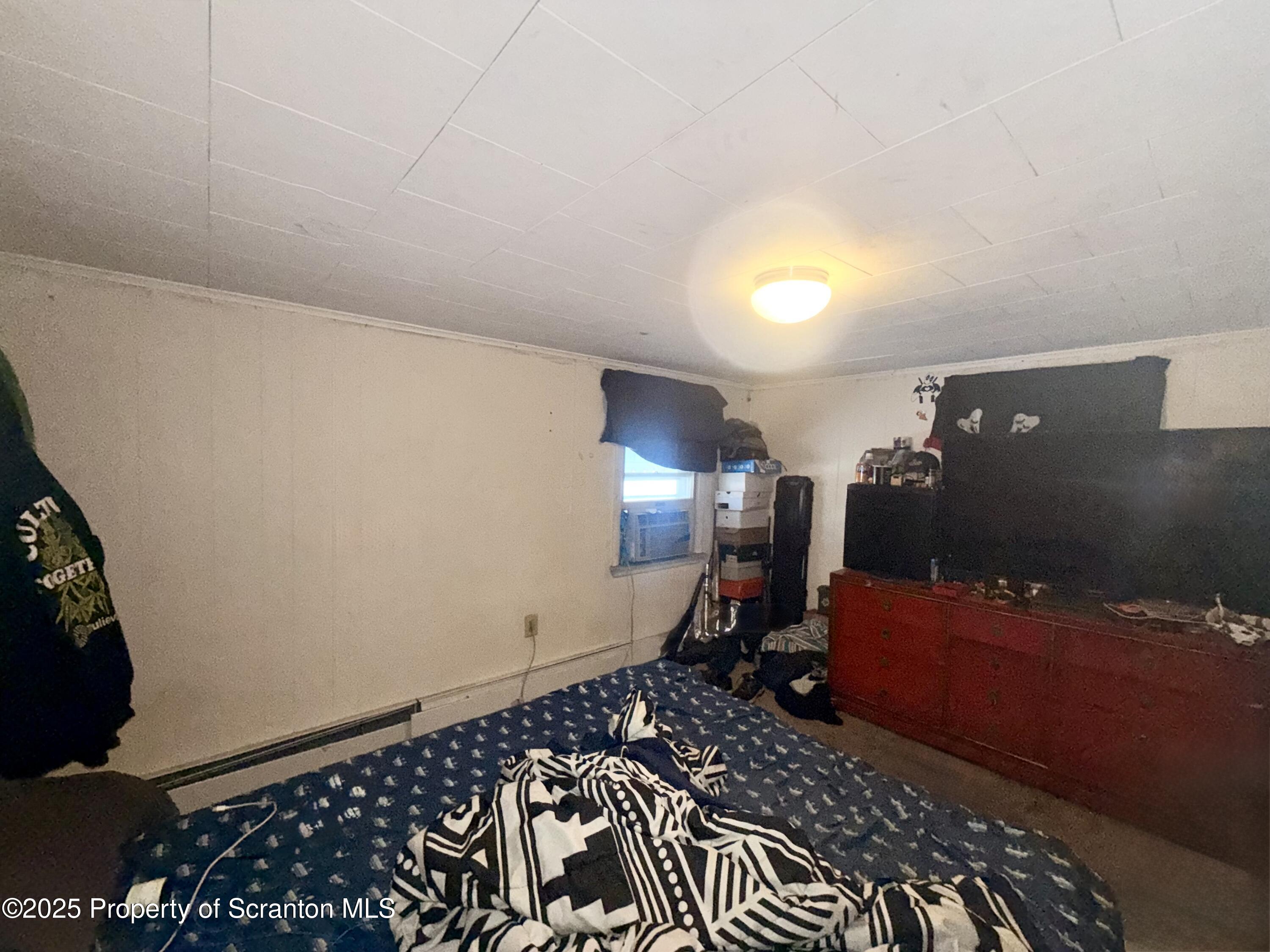 307 Charles Street Old Forge, PA 18518 - Photo 11 of 13 a bedroom with a bed and wooden floor