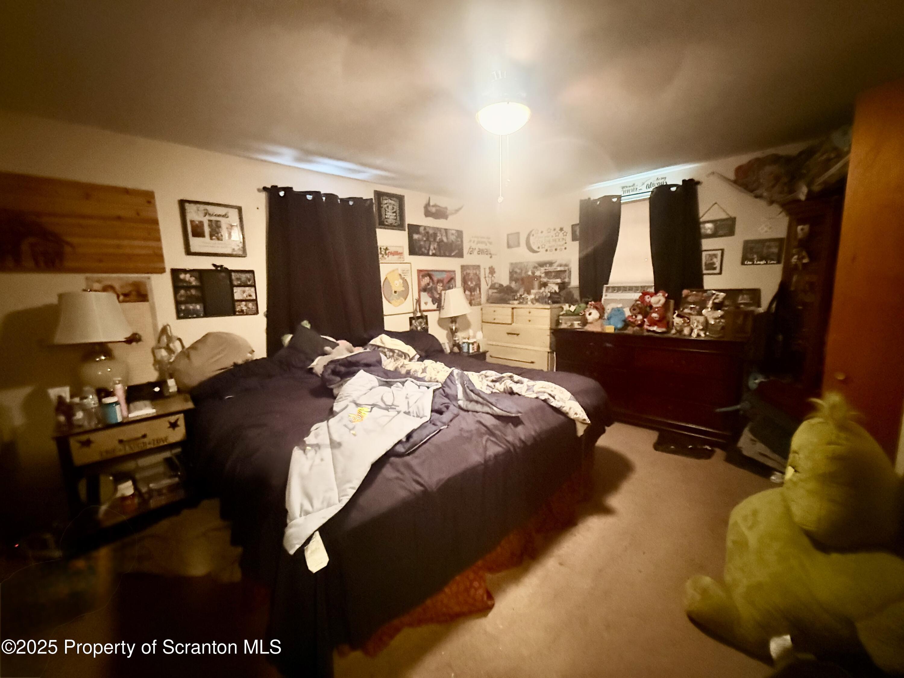 307 Charles Street Old Forge, PA 18518 - Photo 12 of 13 a bed room with a bed window and wall painting