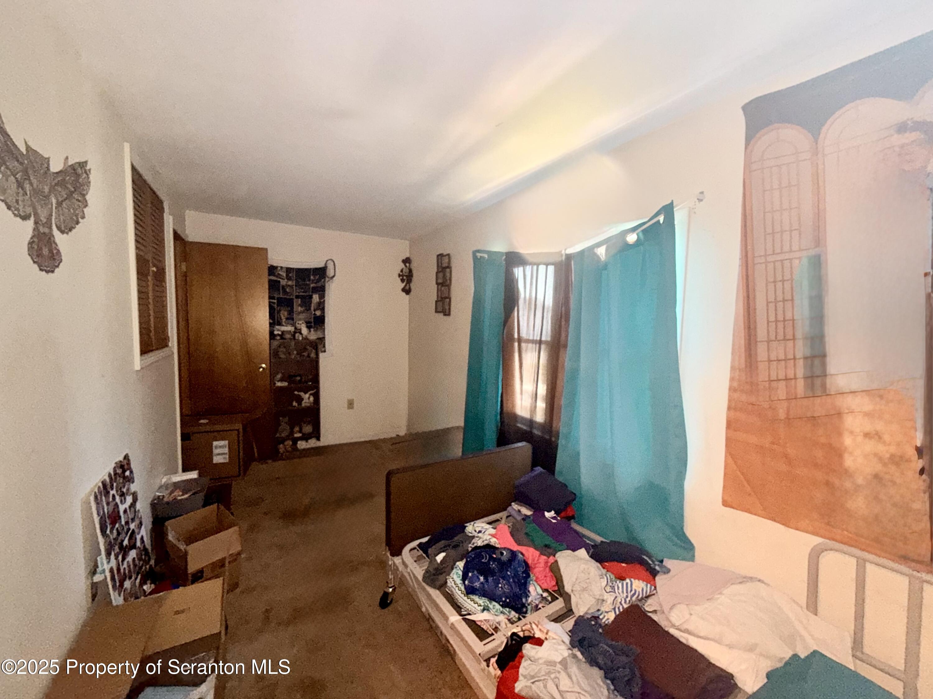 307 Charles Street Old Forge, PA 18518 - Photo 13 of 13 a bedroom with furniture and a window