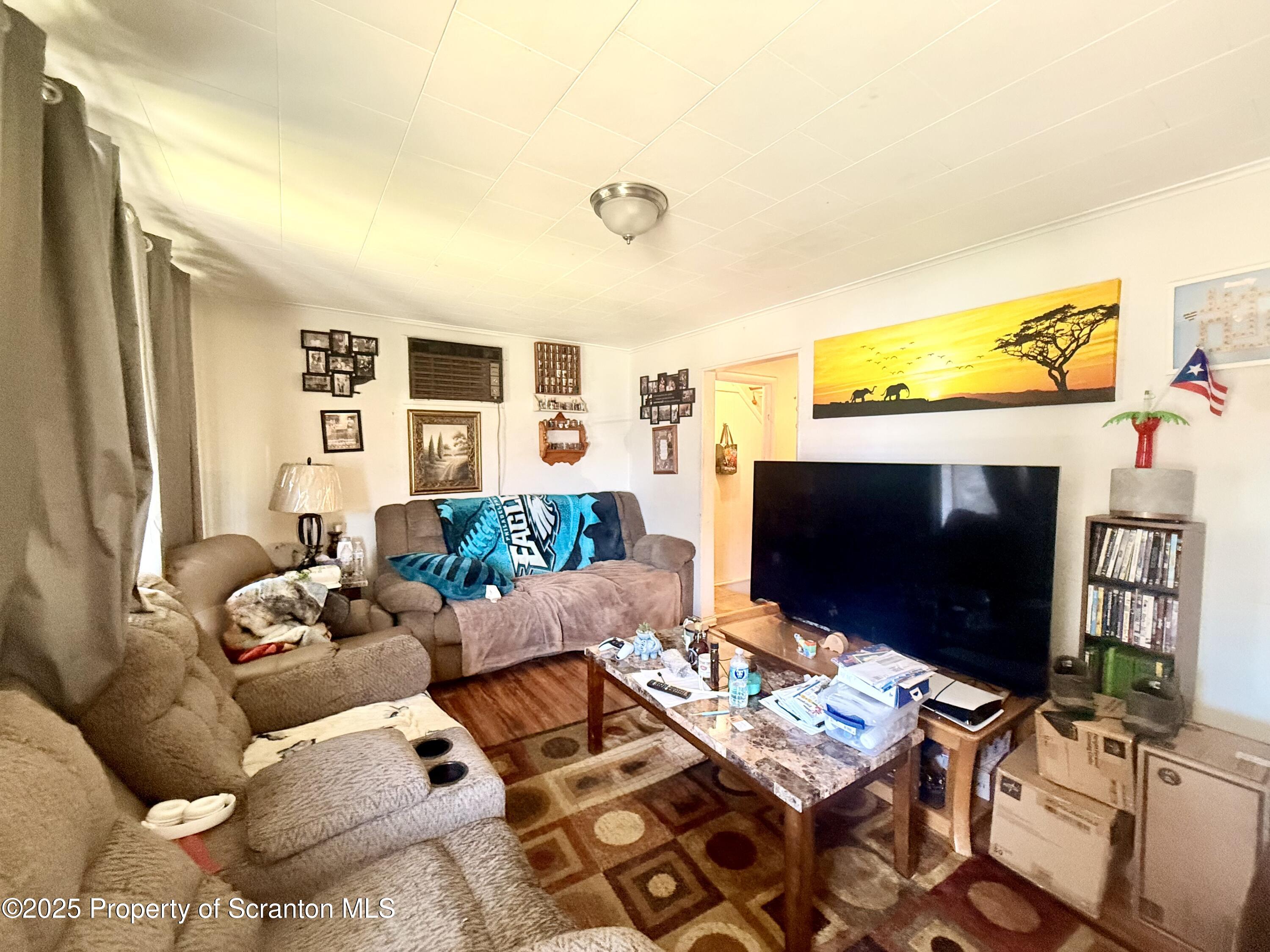 307 Charles Street Old Forge, PA 18518 - Photo 7 of 13 a living room with furniture and a flat screen tv