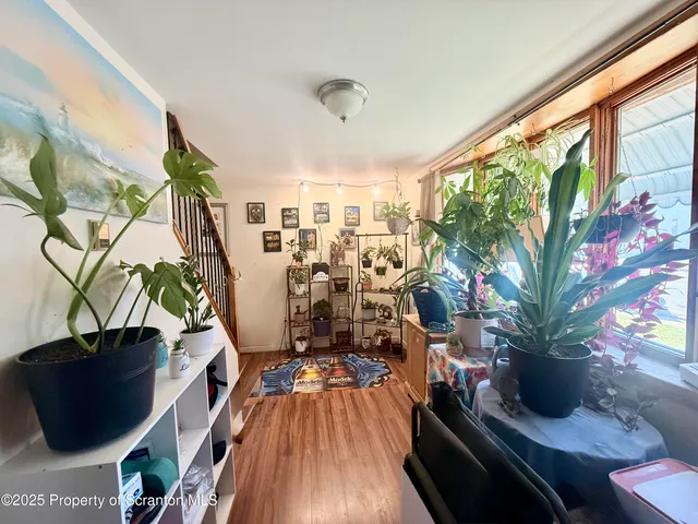 a view of a living room with furniture and floor to ceiling window