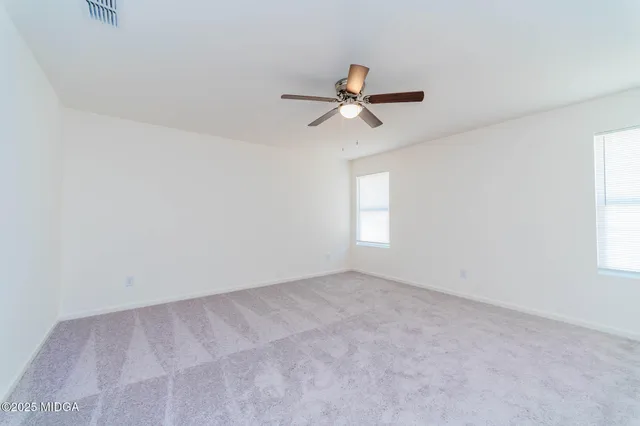 a view of room with a ceiling fan and window