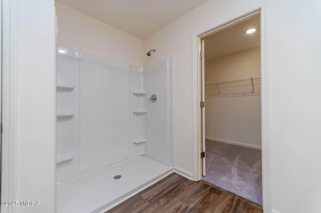 a bathroom with a glass shower door