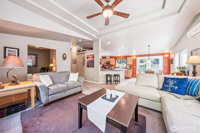 a living room with furniture a ceiling fan and a rug