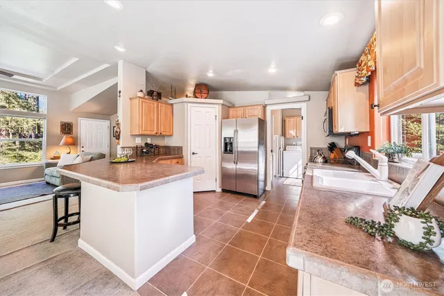 a kitchen with a sink appliances and cabinets