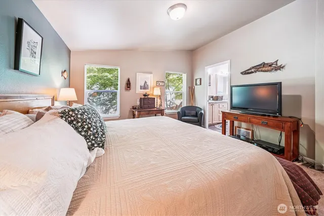 a bedroom with a bed and a flat screen tv