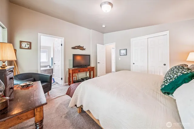 a bedroom with a bed and a flat screen tv