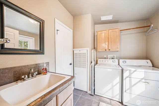 a bathroom with a tub sink and mirror