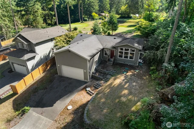 an aerial view of a house with a yard